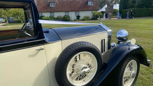 Close-up of the side-mounted spare wheel on a vintage Rolls-Royce 20/25
