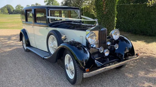 Vintage Rolls-Royce 20/25 wedding car parked on gravel