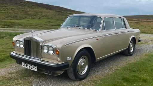 Front left angle of a gold Rolls-Royce Silver Shadow with chrome grille and twin headlights, available for wedding hire in Yorkshire.