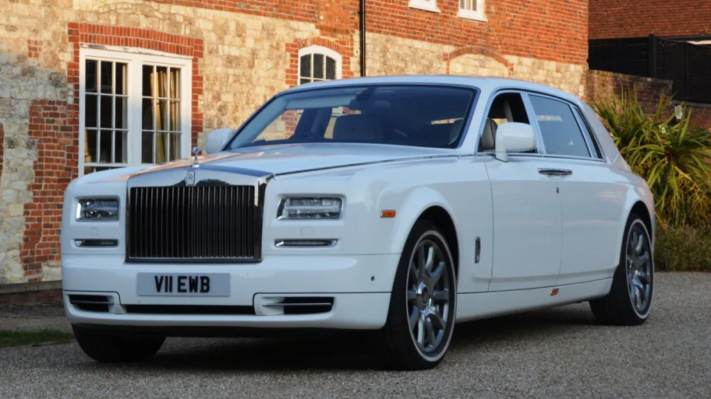 white Rolls-Royce Phantom wth large Chrome front grill and Spirit of Ecstasy sitting atop