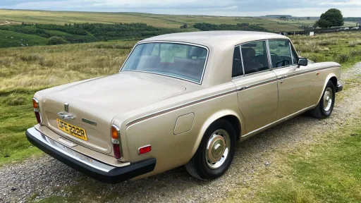 Rear view of a gold Rolls-Royce Silver Shadow showing its classic tail lights and chrome bumper, available for wedding hire in Yorkshire.