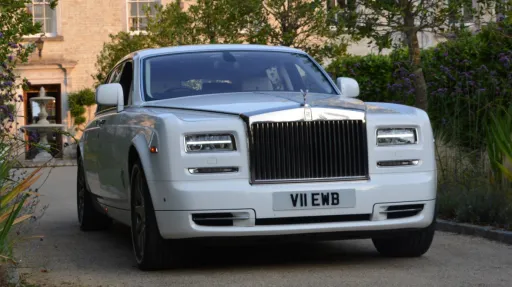 white rolls-royce phantom at theentrance of froyle park