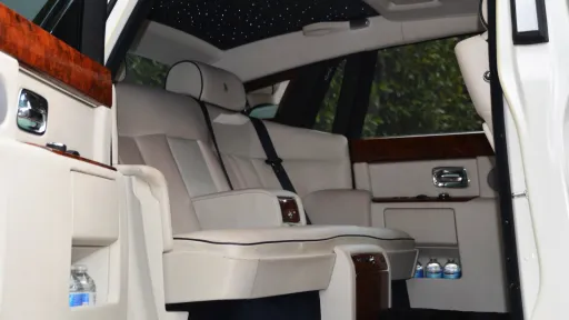 White leather interior with wooden features on top of the door cards and starlight ceiling