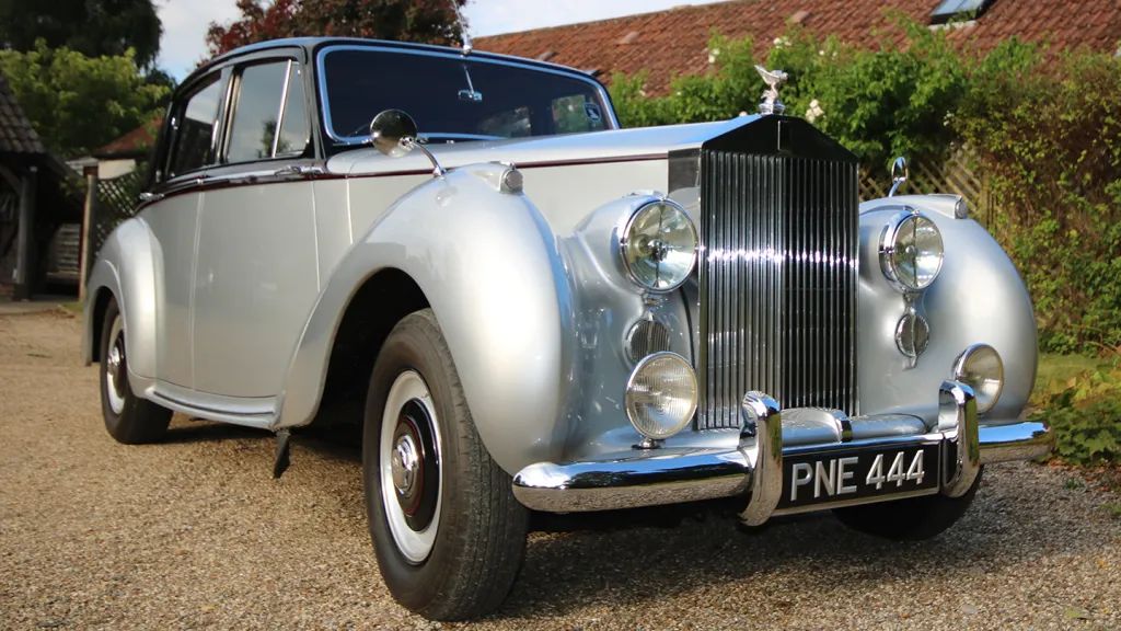 Front view of a 1954 Rolls-Royce Silver Dawn showing its chrome grille, large headlights and registration plate PNE 444.
