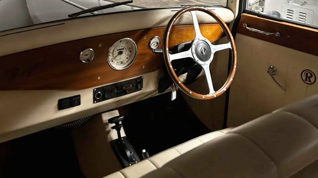 Classic wooden dashboard and steering wheel inside a vintage Regent wedding car, showing traditional dials and leather trim.
