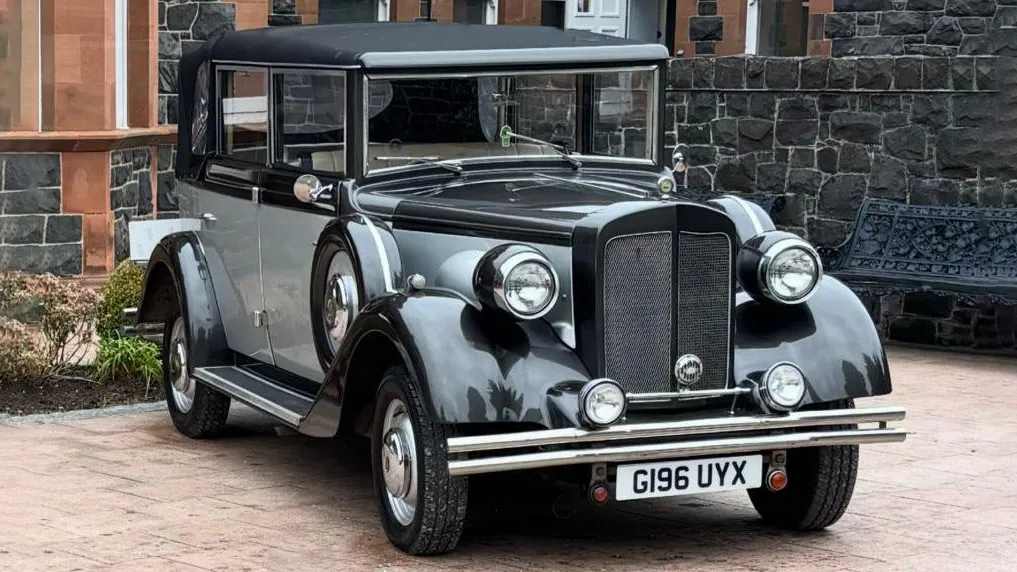 Front angled view of a vintage silver Regent convertible wedding car with black wings and roof, photographed at a wedding in Northern Ireland.