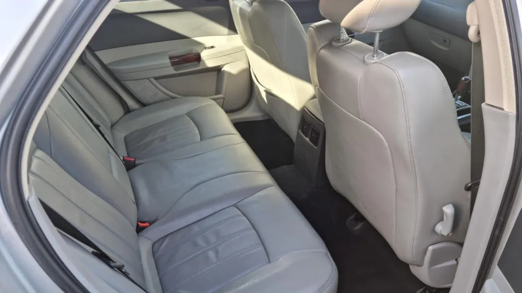 Interior of a Chrysler 300C featuring light silver leather seats and a spacious modern cabin designed for comfort and elegance.