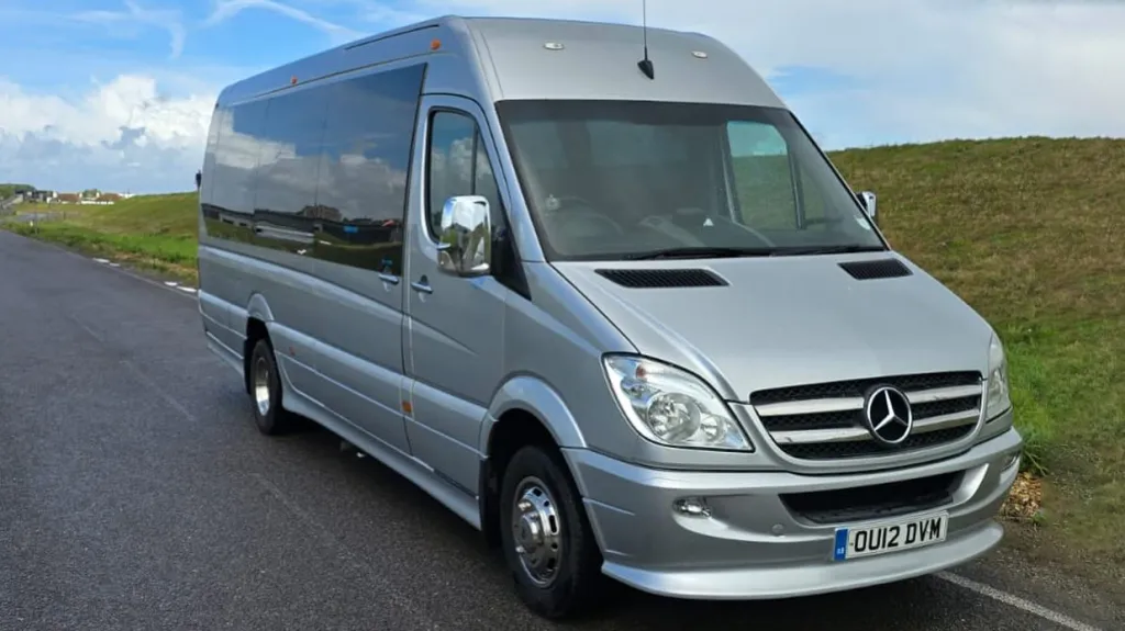 Silver Mercedes 16-seater luxury minibus parked outdoors in Sussex.