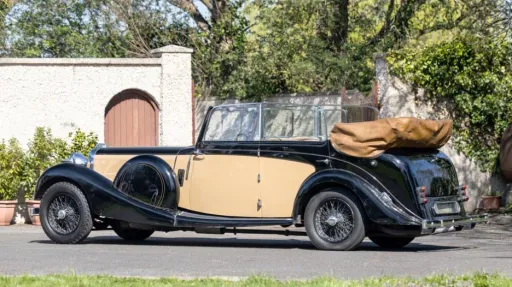 Left side view vintage Lagonda in Ivory with Black wheel arches and convertible roof open