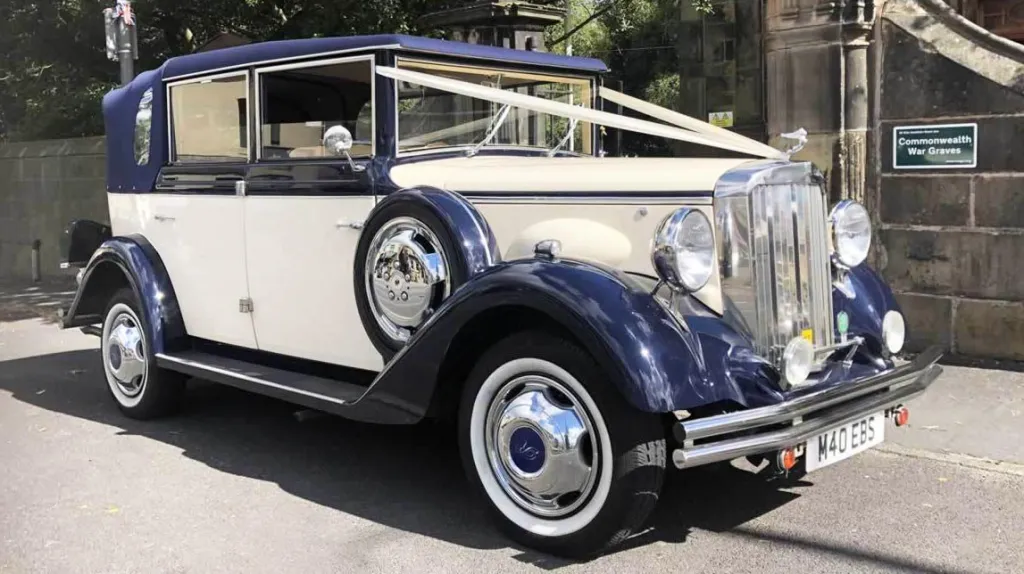 Classic Regent wedding car in two-tone cream and navy blue, photographed in Liverpool with wedding ribbons attached to the bonnet.
