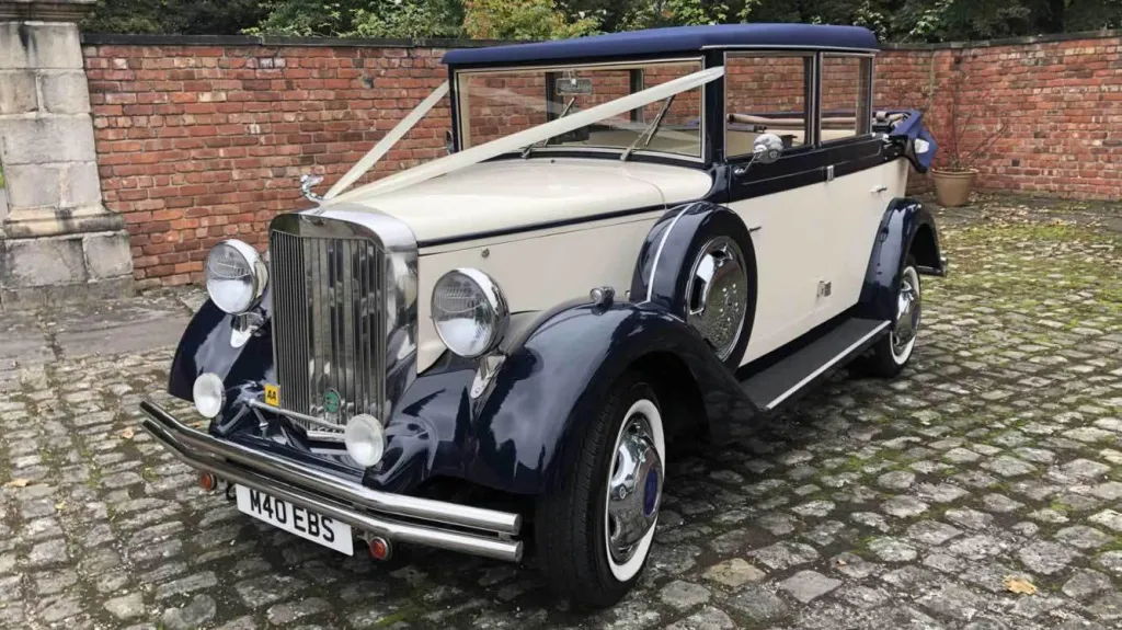Vintage-style Regent wedding car in cream and navy blue, chrome grille and headlights gleaming, available for wedding hire in Liverpool.