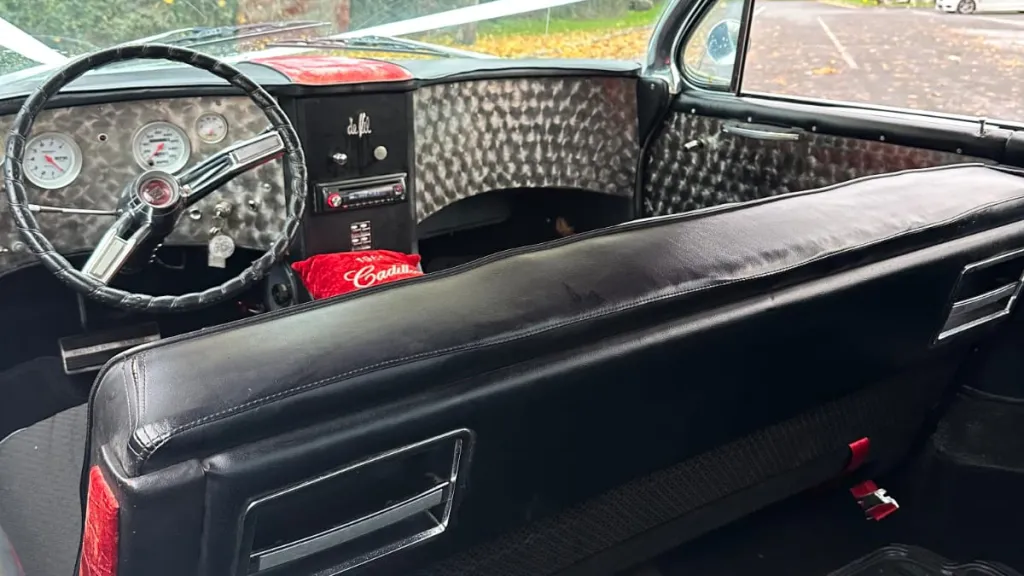 Front dashboard view of a vintage American Cadillac with chrome detailing.