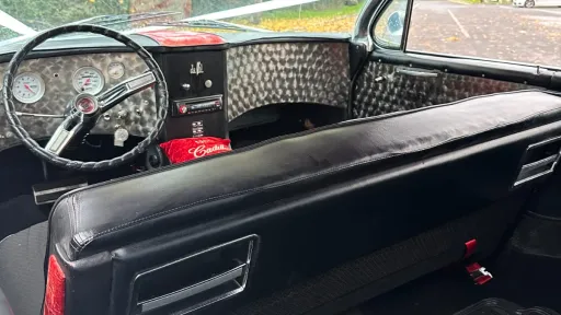 Front dashboard view of a vintage American Cadillac with chrome detailing.