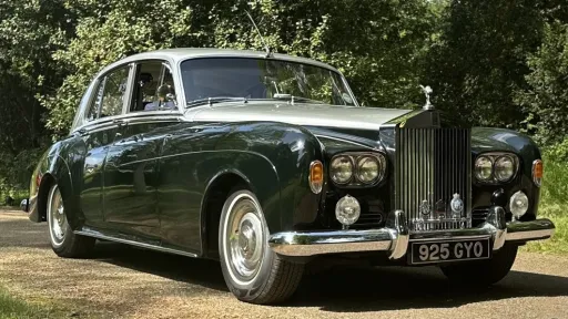 classic green Rolls-Royce Silver Cloud wedding car parked outside venue