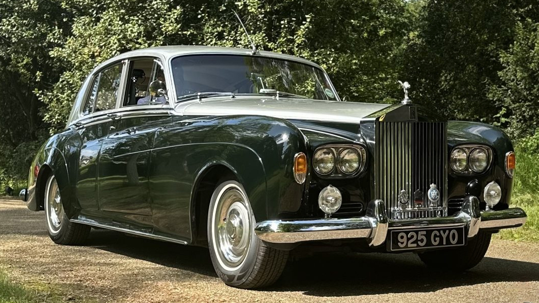 classic green Rolls-Royce Silver Cloud wedding car parked outside venue