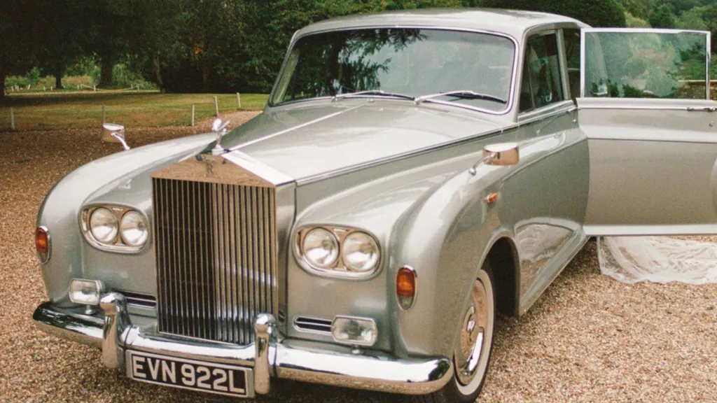 Front view of a silver Rolls-Royce Phantom limousine with chrome grille and Spirit of Ecstasy emblem.