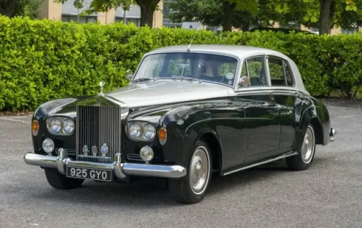 green and silver Rolls-Royce Silver Cloud wedding car parked on driveway