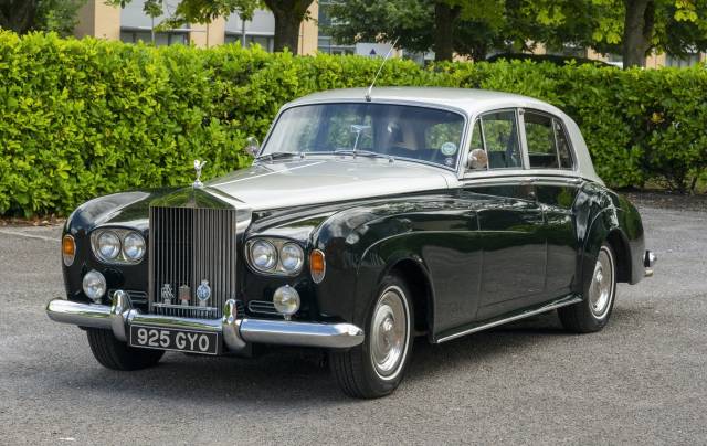 green and silver Rolls-Royce Silver Cloud wedding car parked on driveway