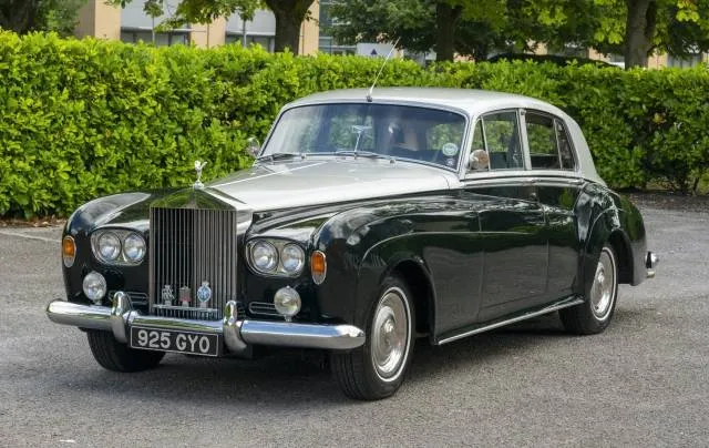 green and silver Rolls-Royce Silver Cloud wedding car parked on driveway
