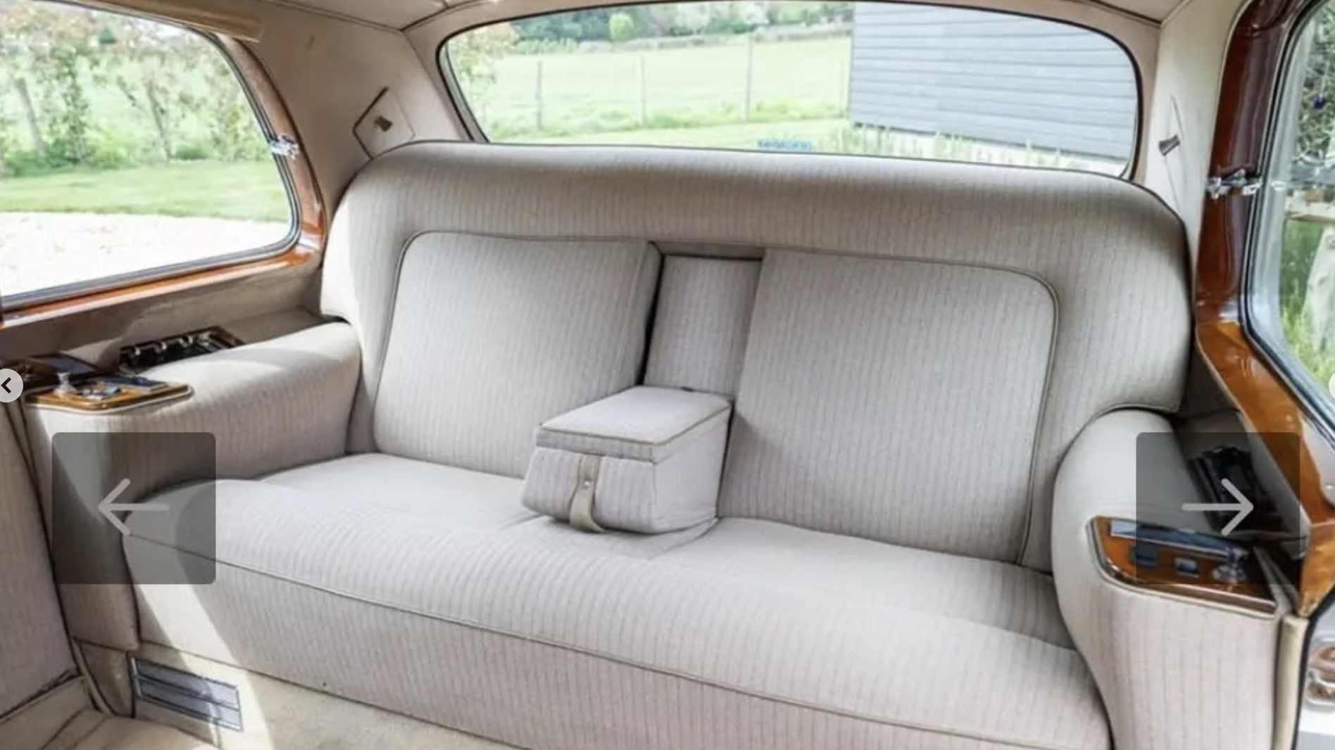 ear interior seats of a classic Rolls-Royce Phantom showing plush upholstery and wood trim.
