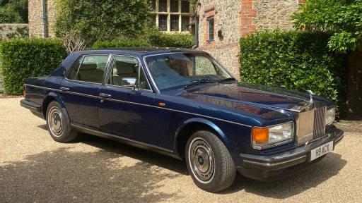 blue Rolls-Royce Silver Spirit parked outside wedding venue