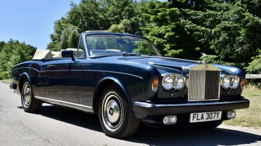Dark Blue Rolls-Royce Corniche with convertible roof open,