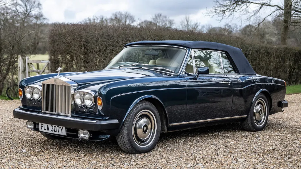 Front left view blue Rolls-royce Corniche with blue soft top roof closed