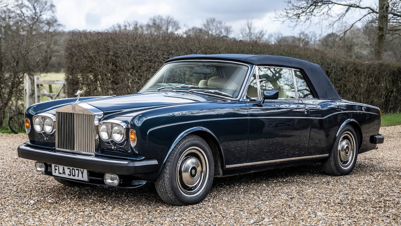 Front left view blue Rolls-royce Corniche with blue soft top roof closed