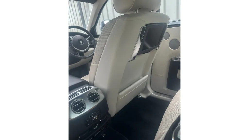 Close-up of the Rolls-Royce Ghost’s cream leather interior, showing luxurious seats and high-end cabin finishes.