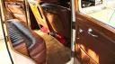 interior brown leather seat with large ledroom and red footrest