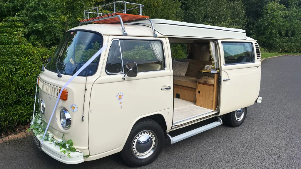 Front Left side view of a classic VW Campervan with rear passenger sliding door open