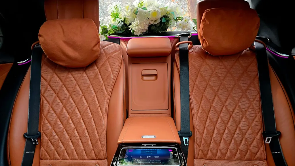 Rear cabin of the Mercedes S-Class 500 featuring luxury tan quilted leather seats and spacious legroom.