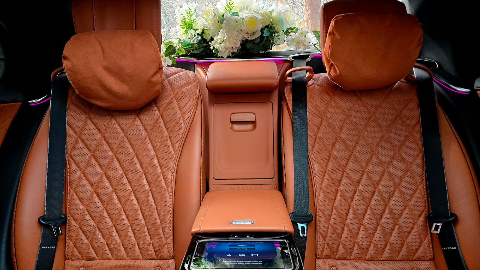 Rear cabin of the Mercedes S-Class 500 featuring luxury tan quilted leather seats and spacious legroom.