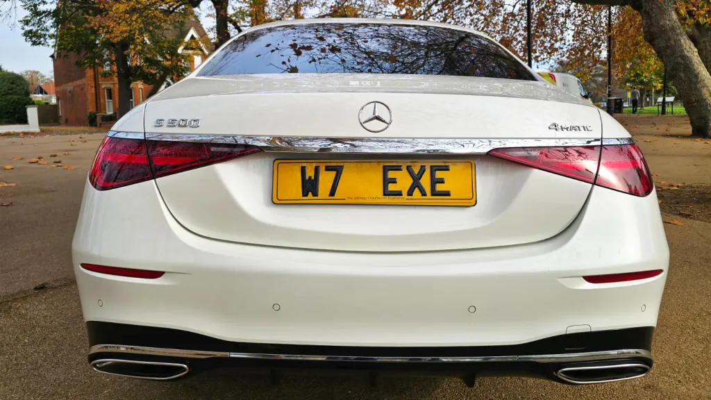 Rear view of a white Mercedes-Benz S-Class 500 with its number plate W7 EXE visible.