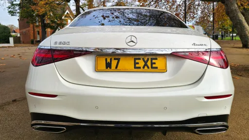 Rear view of a white Mercedes-Benz S-Class 500 with its number plate W7 EXE visible.