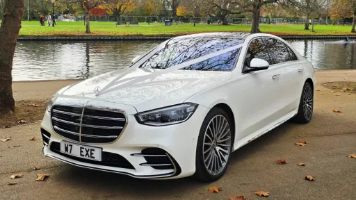 Front three-quarter view of a white Mercedes S-Class 500 available for wedding hire.