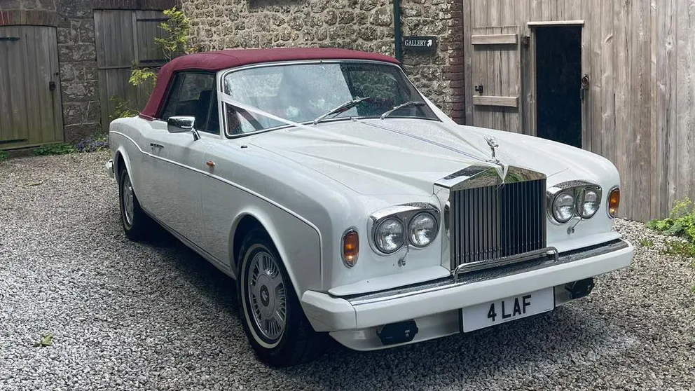 White Rolls-Royce Conriche Convertible with burgundy soft top coof closed