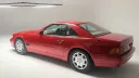 Rear three-quarter view of red Mercedes-Benz SL R129 convertible photographed in studio