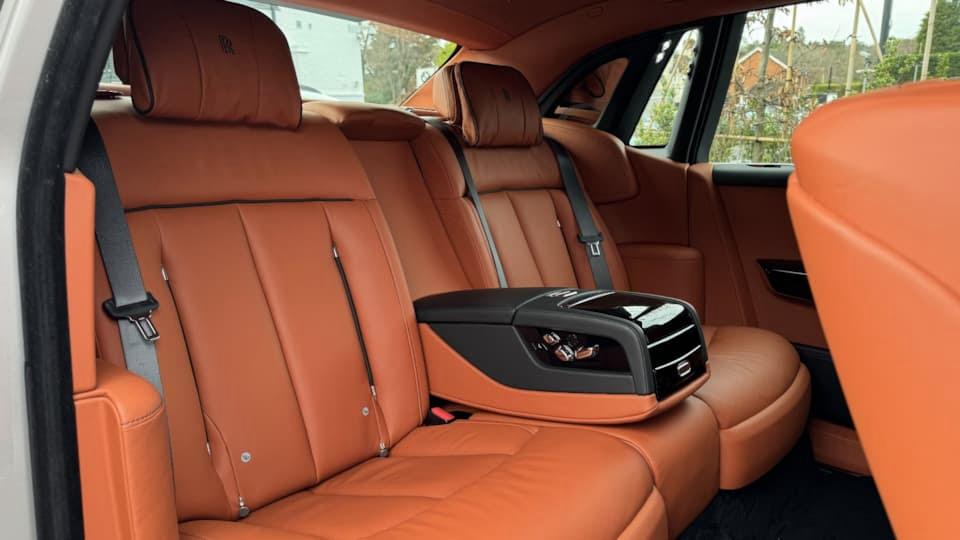 Brown leather rear seats inside black and silver Rolls-Royce Phantom VIII wedding car
