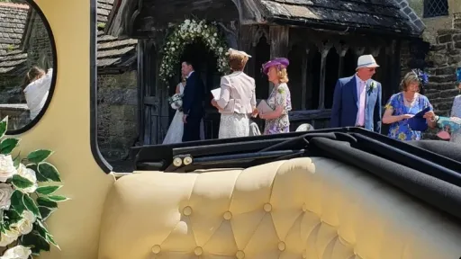 Rear convertible section of a cream 1930s style Imperial wedding car with open roof for wedding photographs.