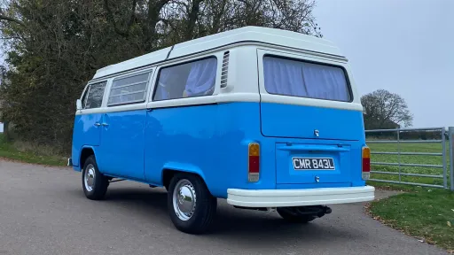 Rear view of a blue Bay Window Volkswagen Campervan Westfalia showing classic body shape and chrome details.