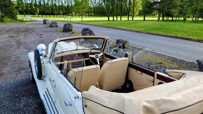 White Vintage Beauford with Convertible Roof open showing Cream Leather interior