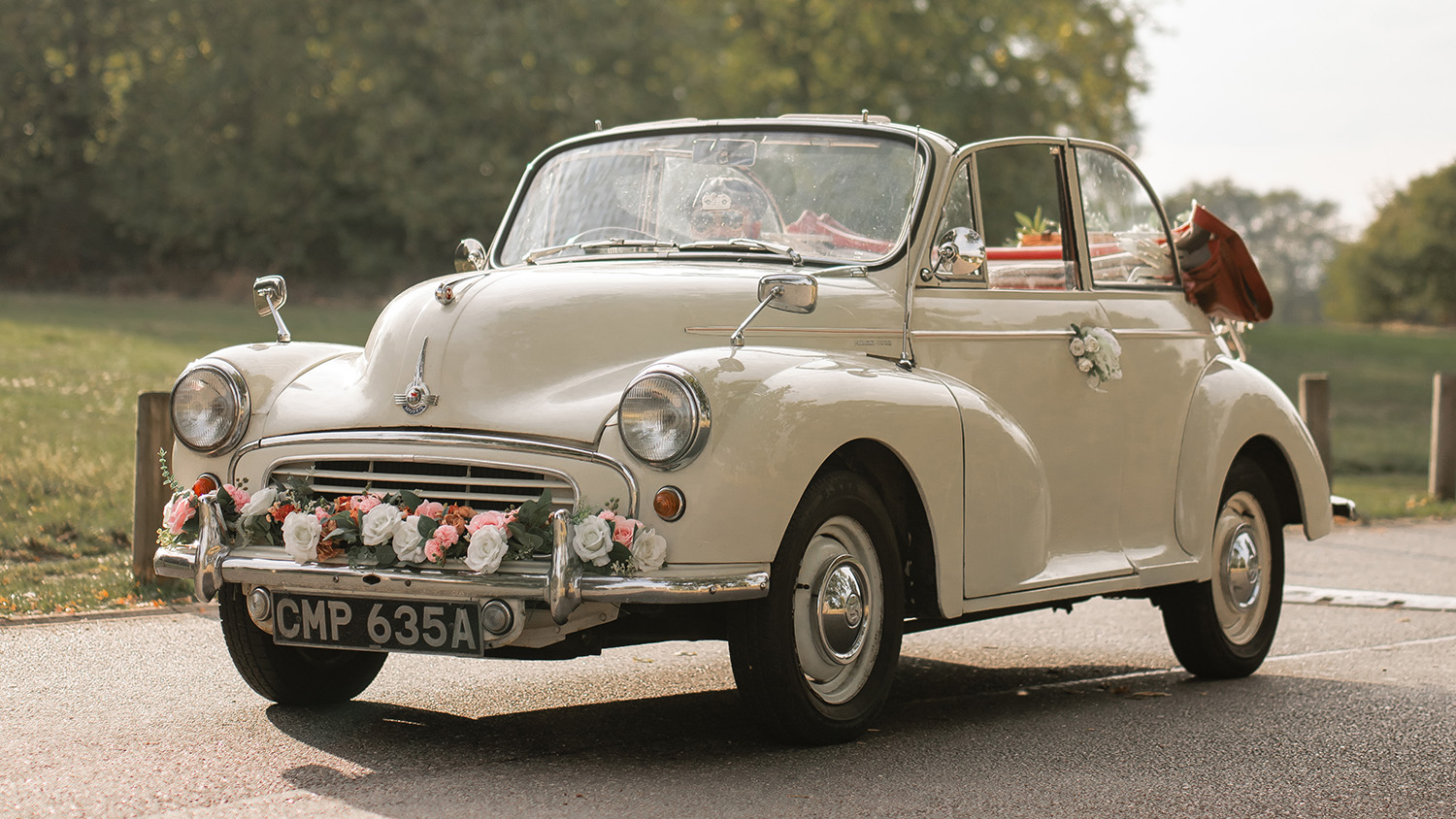 Front three quarter view of cream 1963 Morris Minor Convertible decorated for wedding hire.