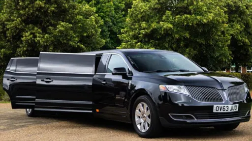 Side view of black Lincoln MKT stretch limo showing long body design and chrome detailing parked outdoors.