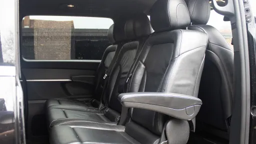 Mercedes V-Class interior showing rear-facing black leather seats with armrests and luxury finish