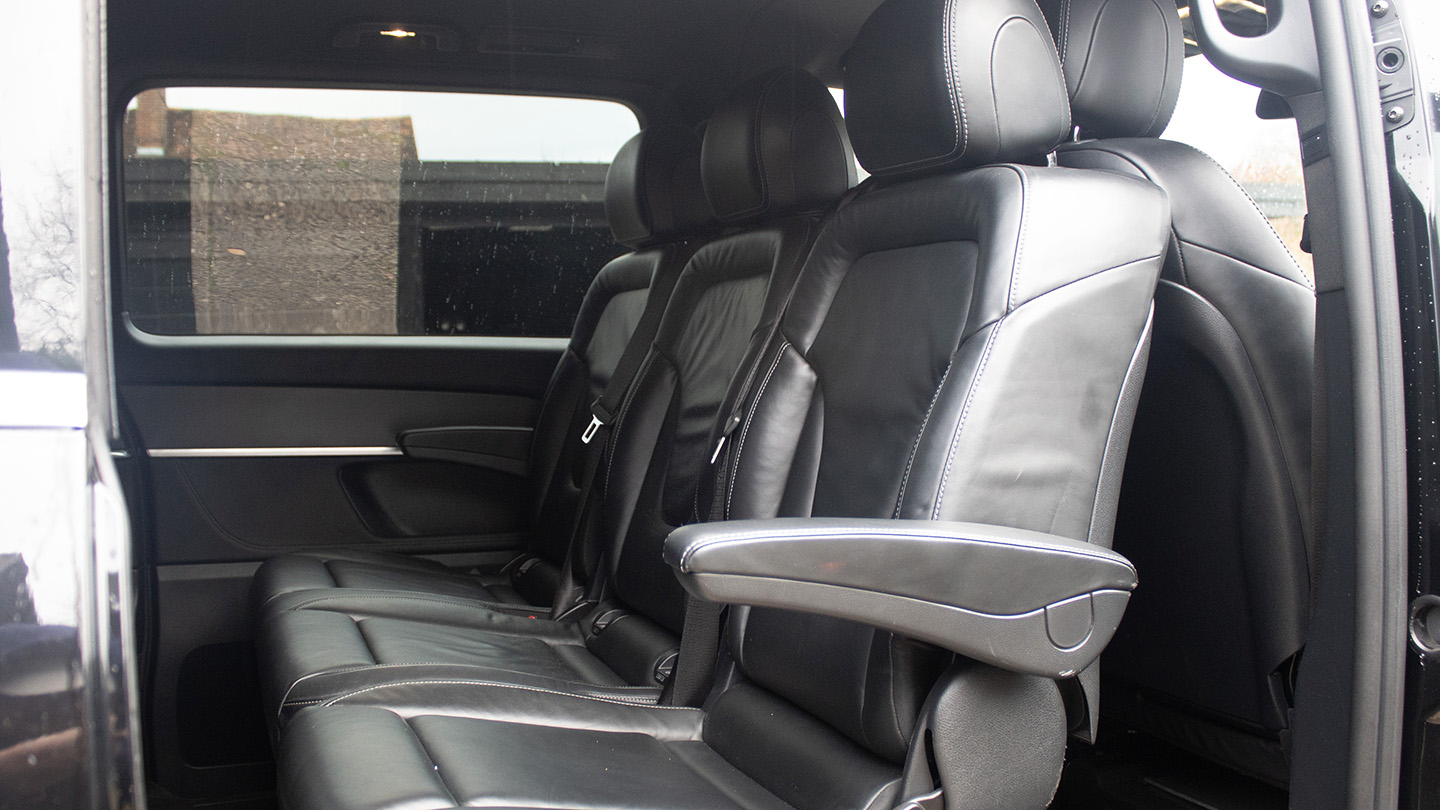 Mercedes V-Class interior showing rear-facing black leather seats with armrests and luxury finish
