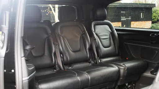 Mercedes V-Class rear cabin with forward-facing black leather seats, spacious executive layout