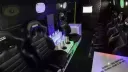 Black leather seats inside a Mini bus with neon light changing colours