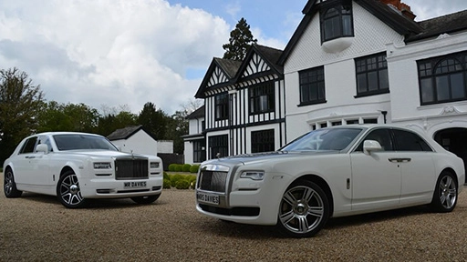 Two white Luxurious Modern Rolls-Royce Ghost and Phantom parked at a local Andover wedding venue