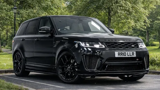 Black ange Rover Sport SVR parked in a park with greenery all around
